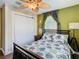 Bedroom with ceiling fan, tropical bedding, and closet at 2904 Sanchez St, Tampa, FL 33605