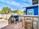 Outdoor deck with grill, bar-height table and chairs, overlooking fenced yard at 2904 Sanchez St, Tampa, FL 33605