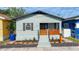 Charming single-story home featuring a cozy front porch with a wooden railing and fresh landscaping at 2904 Sanchez St, Tampa, FL 33605