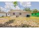 View of a spacious backyard featuring a well maintained lawn and exterior of home at 4812 N 37Th St, Tampa, FL 33610