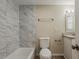 Bathroom with modern white tile, vanity, and a soaking tub at 4812 N 37Th St, Tampa, FL 33610