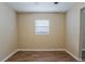 Neutral bedroom featuring wood-look floors, and a window with blinds for privacy at 4812 N 37Th St, Tampa, FL 33610