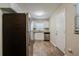 Efficient kitchen featuring stainless steel appliances, white cabinets, granite counters, and wood-look flooring at 4812 N 37Th St, Tampa, FL 33610