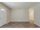 Bright living room with wood-look flooring, neutral paint, and view into dining and hall at 4812 N 37Th St, Tampa, FL 33610