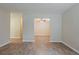 Spacious living area with wood-look floors, and view into dining area with ceiling fan at 4812 N 37Th St, Tampa, FL 33610