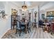 Charming dining area featuring a formal wood table set, light wood floors, and an ornate chandelier at 8721 Crystal Creek Ct, Land O Lakes, FL 34638