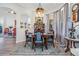 Charming dining area featuring a formal wood table set, light wood floors, and an ornate chandelier at 8721 Crystal Creek Ct, Land O Lakes, FL 34638