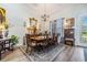 Dining area featuring a classic wood table set, bright natural light, and light wood flooring at 8721 Crystal Creek Ct, Land O Lakes, FL 34638