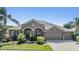 Charming one-story home boasts a well-manicured lawn, mature landscaping, and a three-car garage at 8721 Crystal Creek Ct, Land O Lakes, FL 34638