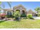 Beautiful one-story home featuring lush landscaping, vibrant green lawn, and a neutral color palette at 8721 Crystal Creek Ct, Land O Lakes, FL 34638
