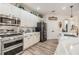 Well-lit kitchen with stainless steel appliances, quartz countertops, and lots of cabinet space at 8721 Crystal Creek Ct, Land O Lakes, FL 34638