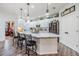 Bright kitchen with stainless appliances, white cabinets, quartz counters, and island seating at 8721 Crystal Creek Ct, Land O Lakes, FL 34638