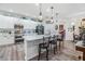 Modern kitchen featuring white cabinets, stainless steel appliances, and a spacious island with bar seating at 8721 Crystal Creek Ct, Land O Lakes, FL 34638