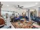 Bright, open-concept living room with modern lighting and elegant furniture flowing into the kitchen at 8721 Crystal Creek Ct, Land O Lakes, FL 34638