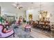 Elegant living room with vaulted ceilings, light wood floors, and an ornate dining set at 8721 Crystal Creek Ct, Land O Lakes, FL 34638