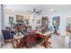 Comfortable living area featuring light walls, light floors, a ceiling fan, and an eclectic mix of furnishings at 8721 Crystal Creek Ct, Land O Lakes, FL 34638