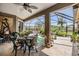 Relaxing screened patio with comfortable seating, a table, and beautiful outdoor views at 8721 Crystal Creek Ct, Land O Lakes, FL 34638