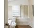 Compact bathroom featuring modern flooring, neutral paint, and a toilet with white beadboard at 1424 14Th S St, St Petersburg, FL 33705