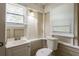 Bathroom featuring toilet and sink in a room with a window, blinds, and overhead lighting at 1424 14Th S St, St Petersburg, FL 33705