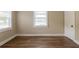 Cozy bedroom with wood flooring, neutral walls, and a window offering natural light at 1424 14Th S St, St Petersburg, FL 33705