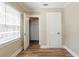 Bright bedroom with neutral paint, modern wood flooring, and natural light from window with blinds at 1424 14Th S St, St Petersburg, FL 33705