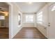 Inviting entryway features wood floors, soft beige walls, and natural light streaming through the windows at 1424 14Th S St, St Petersburg, FL 33705