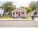 Charming single-story home with stone accents, a red front door, and a well-maintained yard at 1424 14Th S St, St Petersburg, FL 33705
