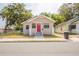Charming single-story home with stone accents, a red front door, and a well-maintained yard at 1424 14Th S St, St Petersburg, FL 33705