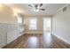 Bright living room with hardwood floors, neutral walls, ceiling fan, and decorative fireplace at 1424 14Th S St, St Petersburg, FL 33705