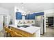 Bright kitchen with stylish blue cabinets, stainless steel appliances, and a breakfast bar with seating at 2356 Kingston S St, St Petersburg, FL 33711