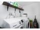 Well-equipped laundry room with modern washer and dryer, plus storage shelving at 2356 Kingston S St, St Petersburg, FL 33711