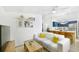 Cozy living room flows into a kitchen with a breakfast bar, featuring a comfortable sofa and bright decor at 2356 Kingston S St, St Petersburg, FL 33711