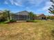 Spacious backyard with a screened-in patio, providing an ideal outdoor living space at 2936 Banyan Hill Ln, Land O Lakes, FL 34639