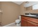 Bathroom features a granite countertop, wooden vanity and modern fixtures at 738 Haven Pl, Tarpon Springs, FL 34689