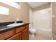 Bathroom features a granite countertop, wooden vanity, tub and shower at 738 Haven Pl, Tarpon Springs, FL 34689