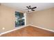 Cozy bedroom with large window and ceiling fan at 738 Haven Pl, Tarpon Springs, FL 34689