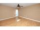 Bright bedroom featuring neutral paint, wood floors, ceiling fan, and natural light at 738 Haven Pl, Tarpon Springs, FL 34689