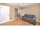 Bedroom with a ceiling fan, sofa, neutral paint and wood floors at 738 Haven Pl, Tarpon Springs, FL 34689