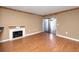 Living room with fireplace, hardwood floors, and sliding glass doors to backyard at 738 Haven Pl, Tarpon Springs, FL 34689