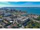 Beautiful aerial view of modern apartment building surrounded by city, bay, landscaping, and a pool at 1064 N Tamiami Trl # 1219, Sarasota, FL 34236
