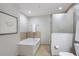 Bright bathroom featuring a soaking tub and glass enclosed shower at 1064 N Tamiami Trl # 1219, Sarasota, FL 34236