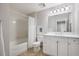 Bright bathroom featuring a shower-tub combo and single sink vanity with ample cabinet space at 1064 N Tamiami Trl # 1219, Sarasota, FL 34236