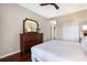Well-appointed bedroom featuring hardwood floors, a dresser, and a comfortable bed, creating a restful and inviting retreat at 1064 N Tamiami Trl # 1219, Sarasota, FL 34236