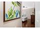 Cozy bedroom featuring rich hardwood floors, a large window, and a decorative wall painting, creating a serene and inviting space at 1064 N Tamiami Trl # 1219, Sarasota, FL 34236