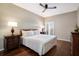 Comfortable bedroom with hardwood floors, a ceiling fan, and natural light, creating a peaceful and relaxing environment at 1064 N Tamiami Trl # 1219, Sarasota, FL 34236