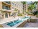 Beautiful courtyard with lush landscaping, tranquil fountain, and attractive tile work at 1064 N Tamiami Trl # 1219, Sarasota, FL 34236