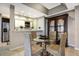 Dining area featuring tile floors, an adjacent modern kitchen, and a decorative china cabinet at 1064 N Tamiami Trl # 1219, Sarasota, FL 34236