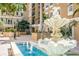 Stunning fountain in courtyard with blue water, intricate stone design and mature landscaping at 1064 N Tamiami Trl # 1219, Sarasota, FL 34236