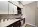 Kitchen features white quartz countertops, and sleek dark wood and white cabinetry at 1064 N Tamiami Trl # 1219, Sarasota, FL 34236