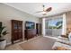 Inviting living room with a ceiling fan and a sliding glass door leading to the balcony, bathed in natural light at 1064 N Tamiami Trl # 1219, Sarasota, FL 34236